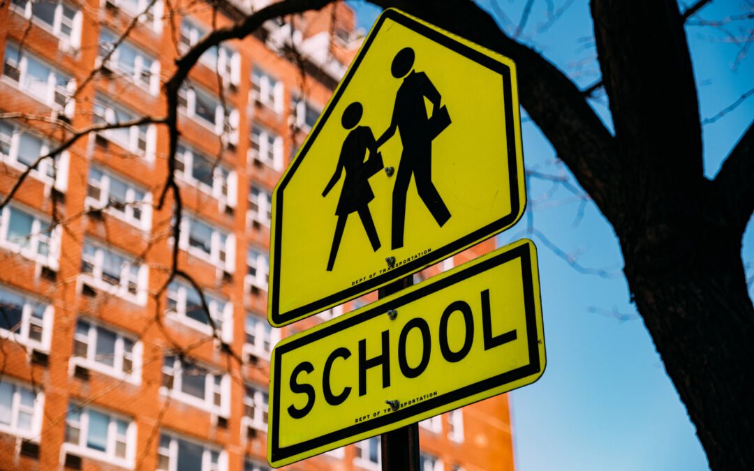 Road sign in downtown of city showing schools near fox crossings